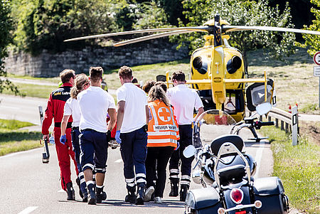 Helfer vor Ort und Rettungsdienst Arbeiten Hand in Hand
